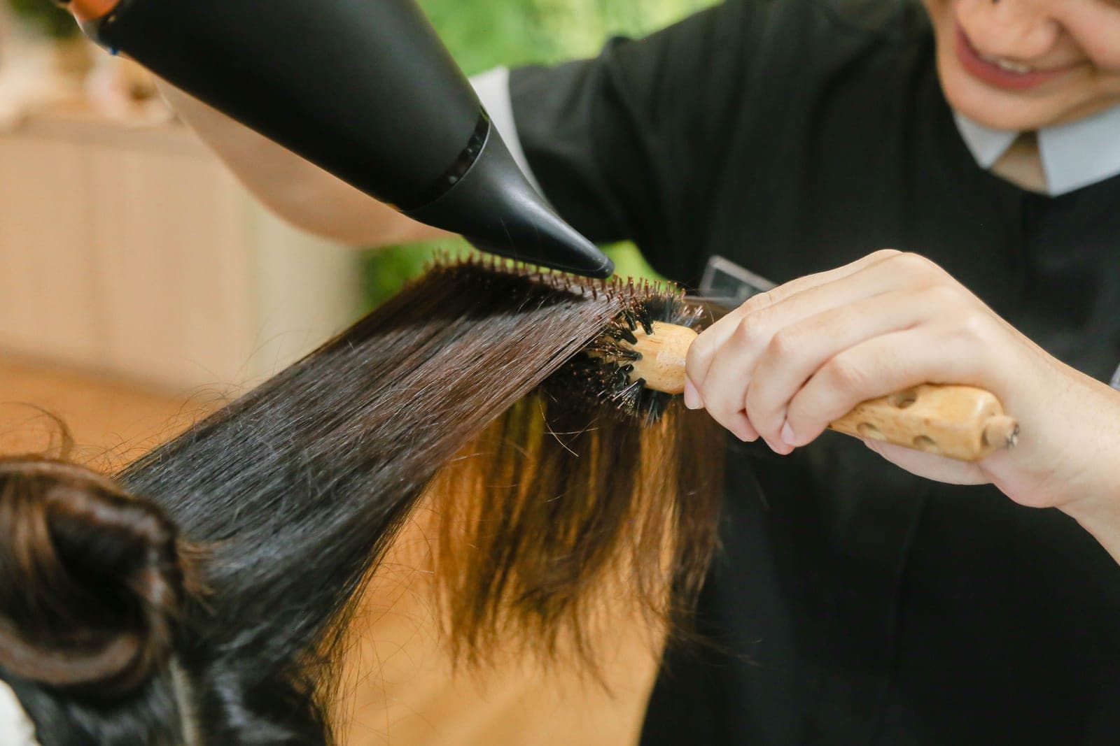 Thick hair being brushed and dried