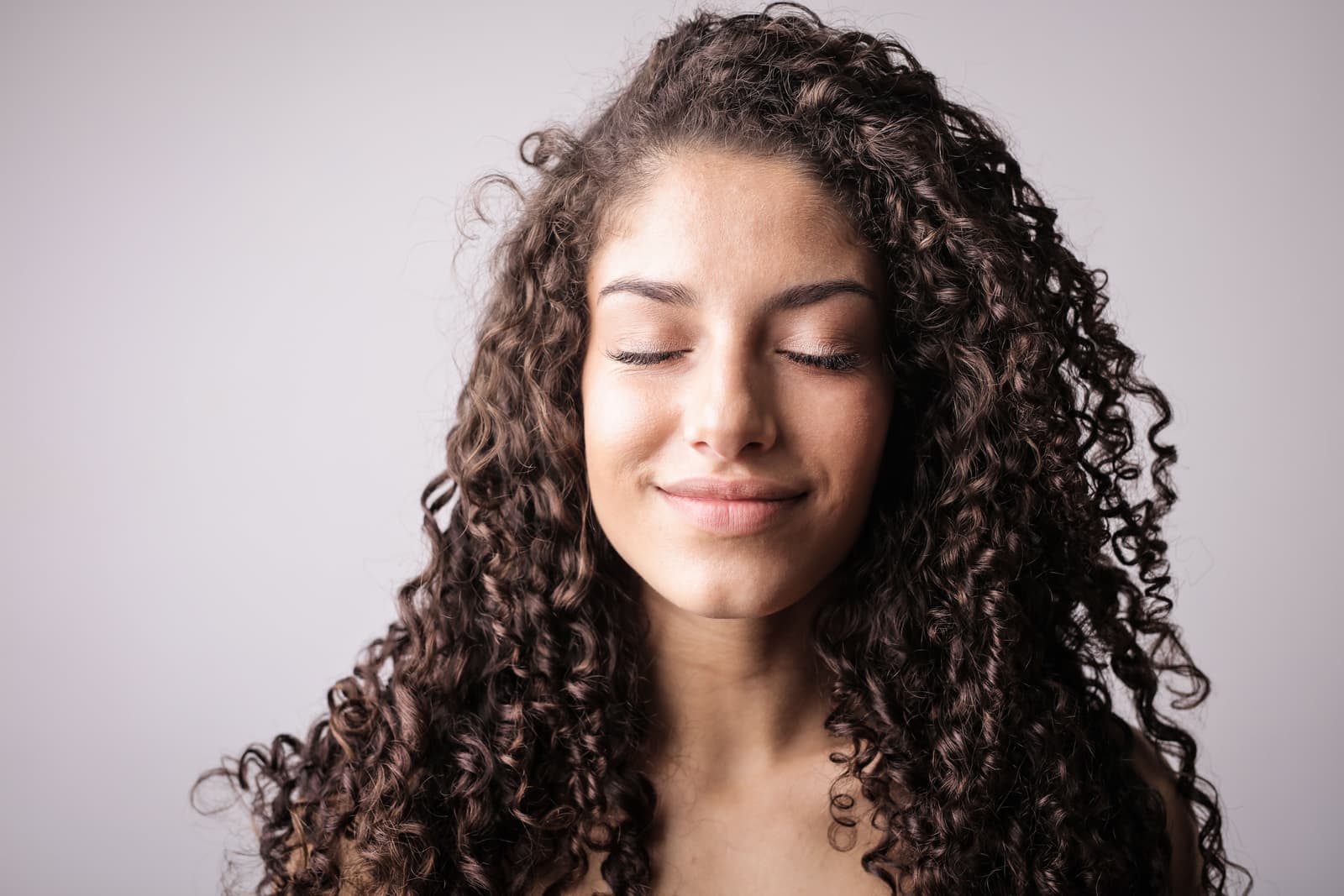 Long thick hair styled into spiral curls