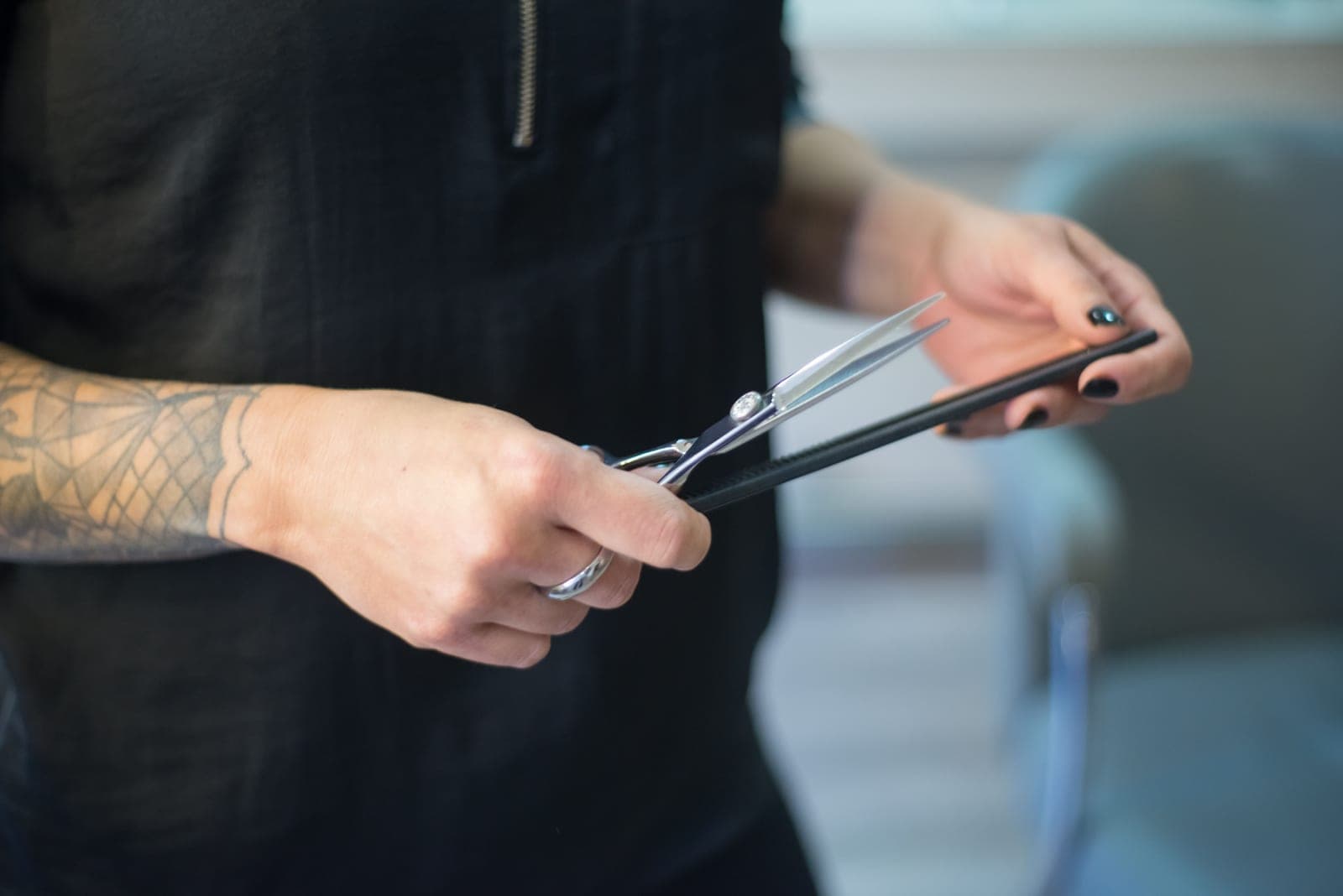 Hands choosing between two hair styling tools