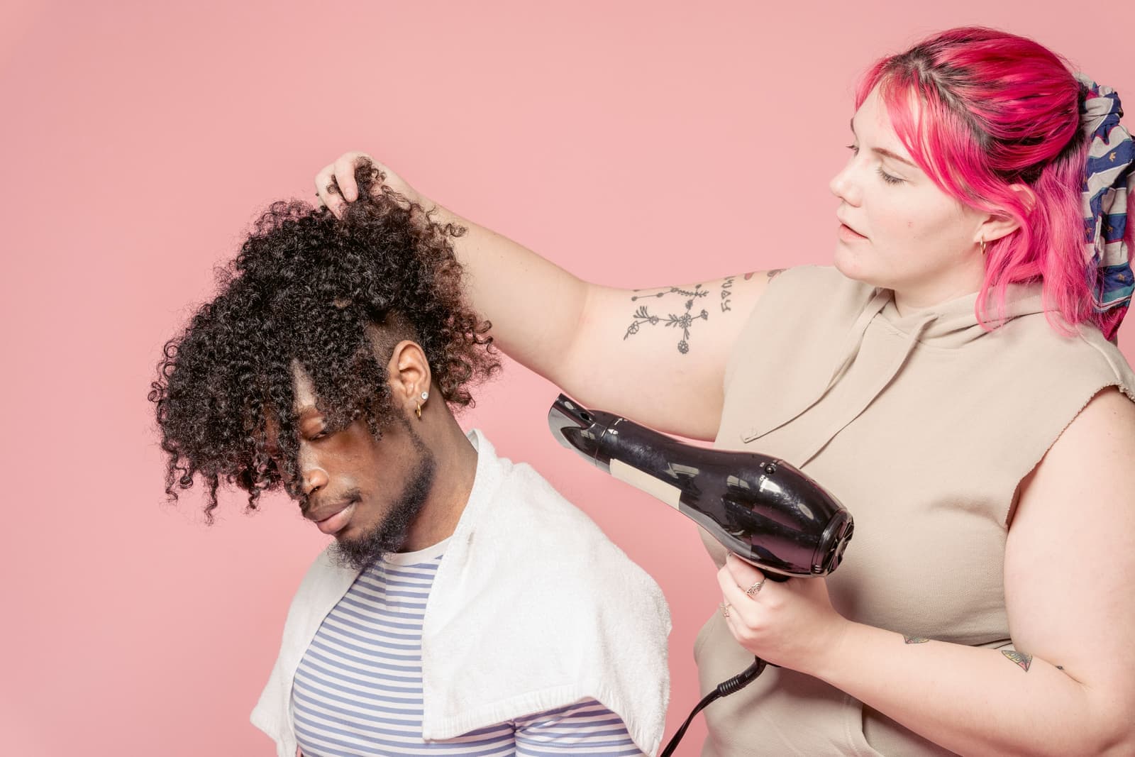 Curly hair being dried with a diffuser attachment
