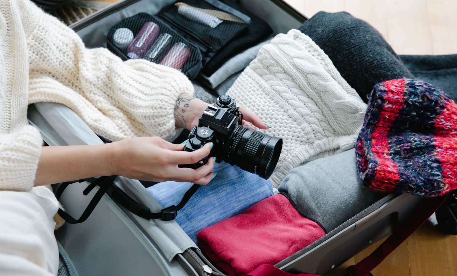 A suitcase being packed with travel toiletries