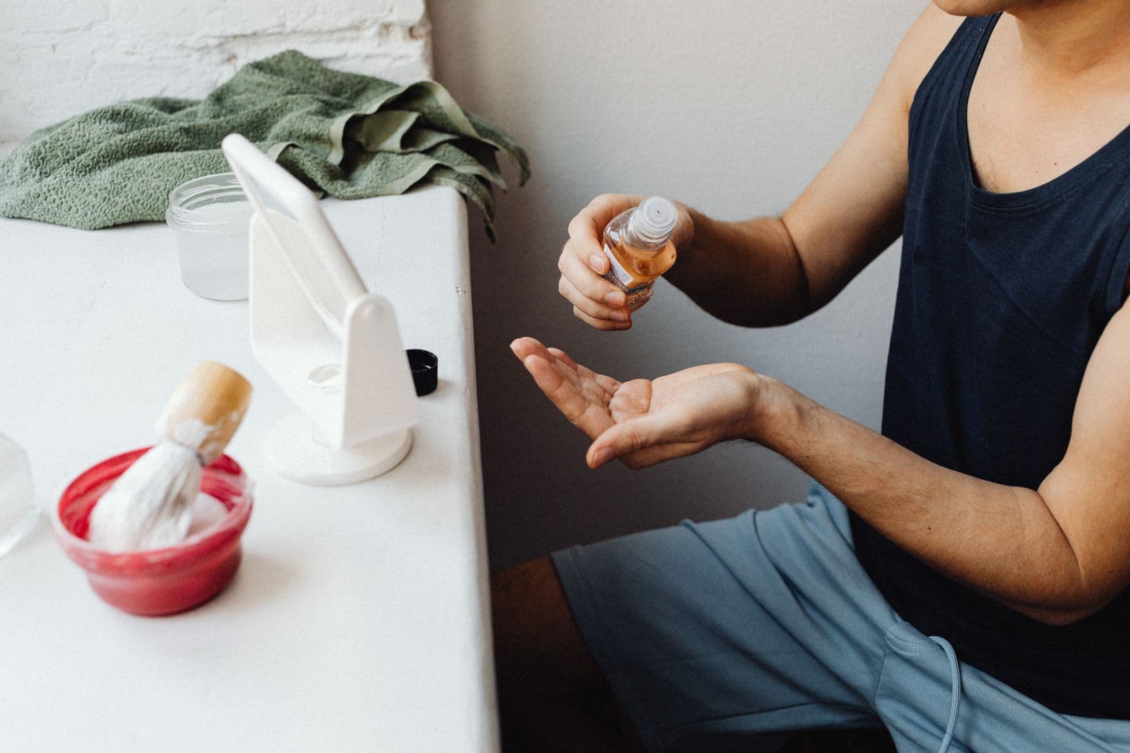 Aftershave and shaving accessories on a bathroom counter