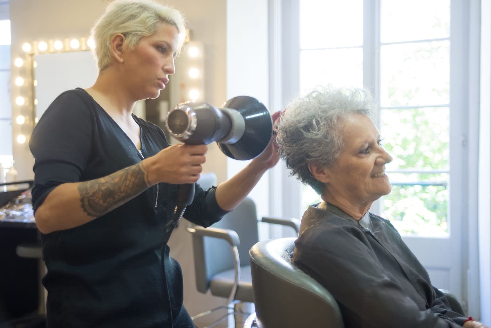 A professional hair dryer in use during a salon blowout