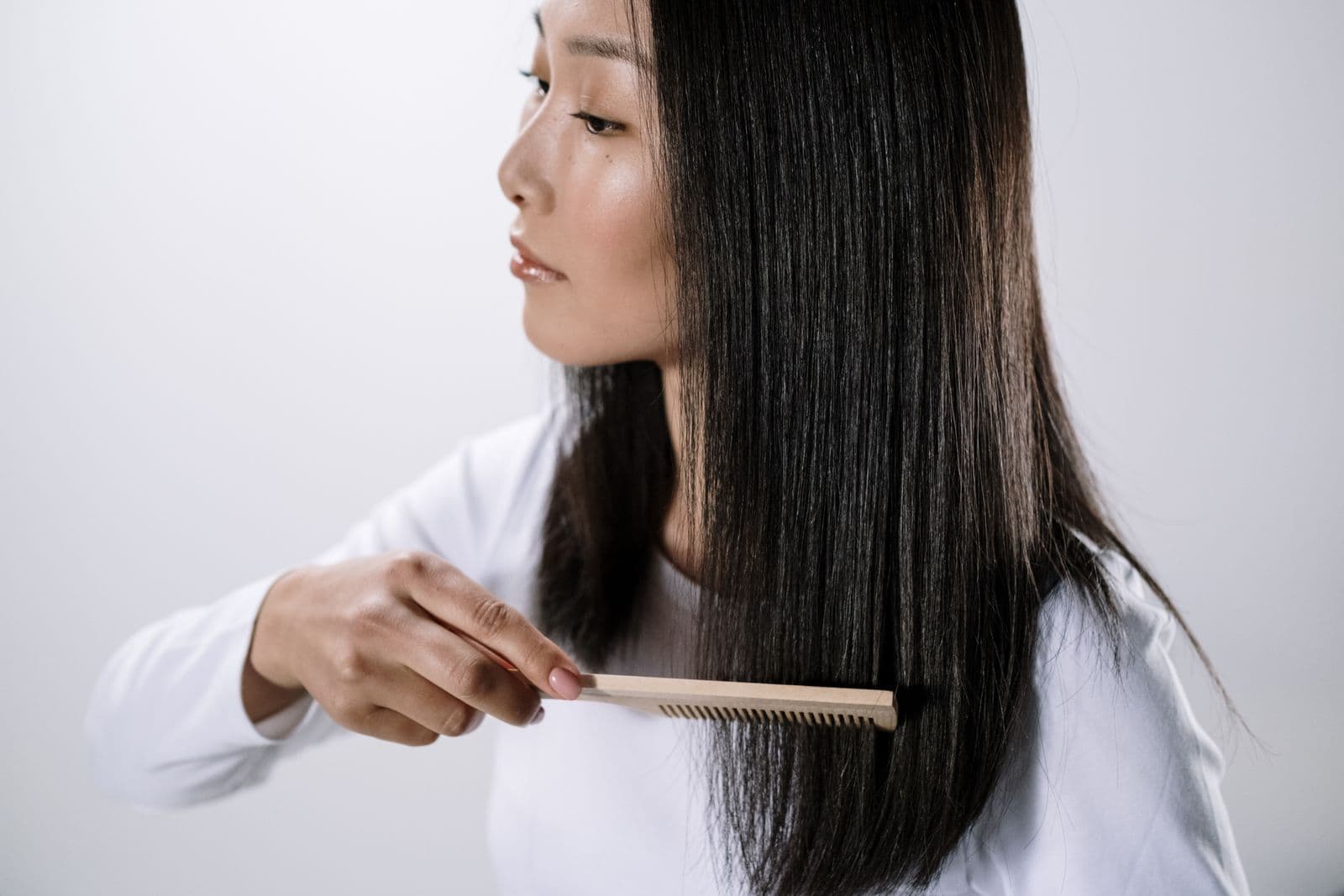 A woman combing her long straight hair
