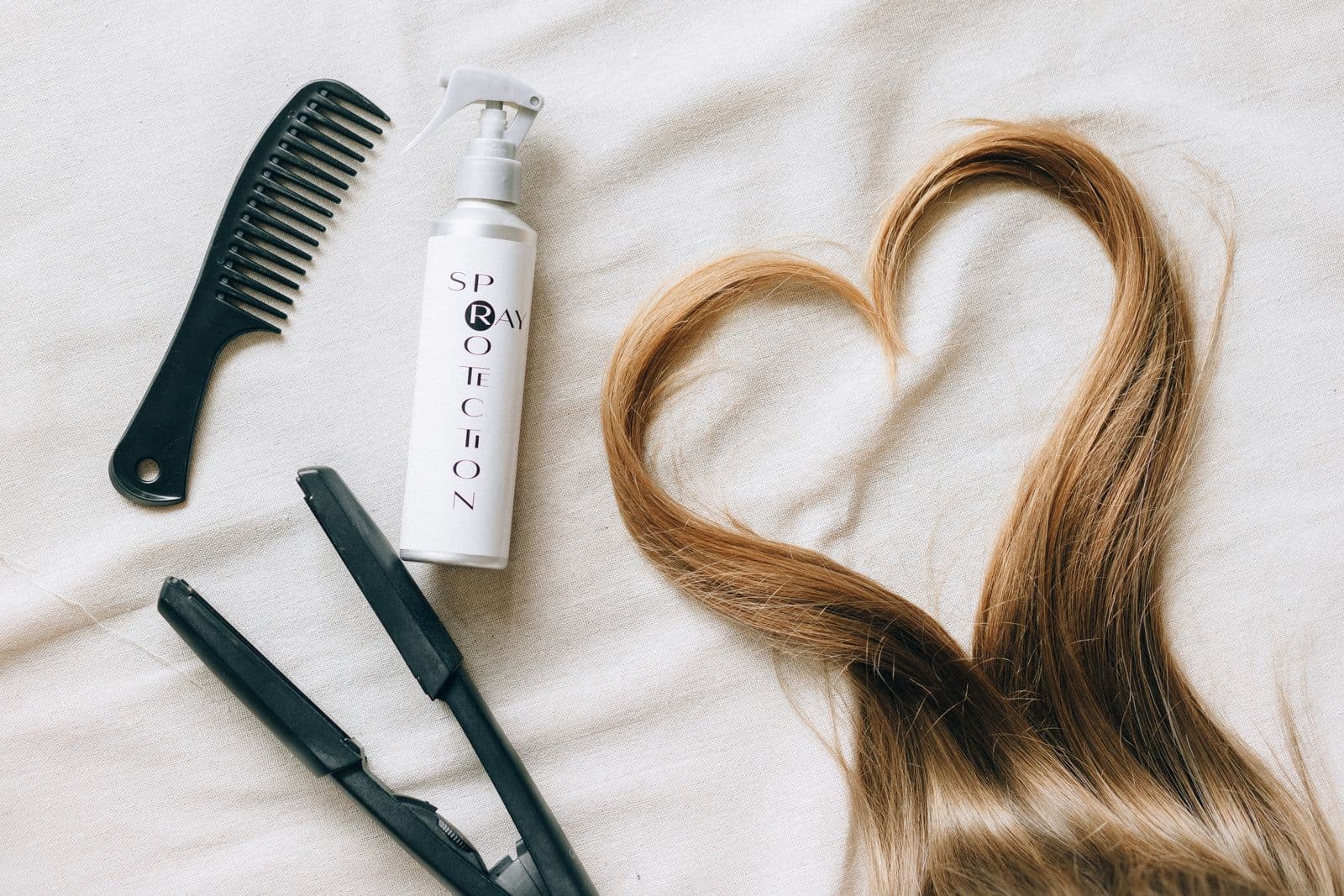 A cordless flat iron on a styling surface