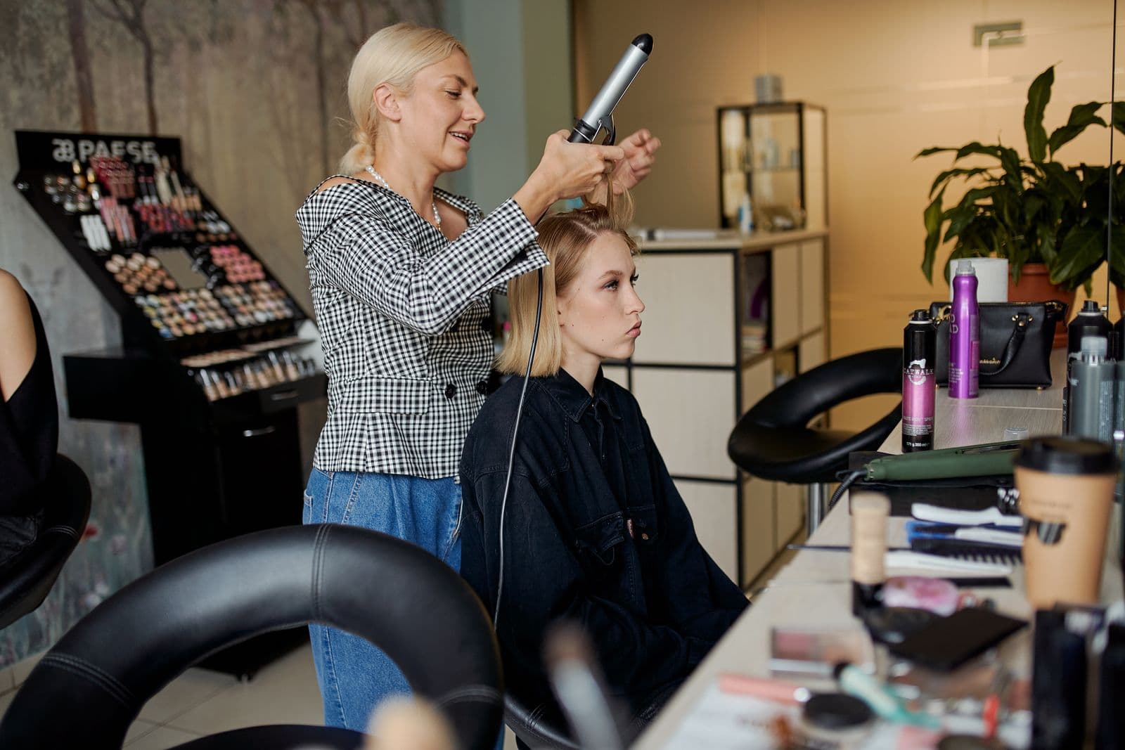 Smoothing a section of hair with a flat iron