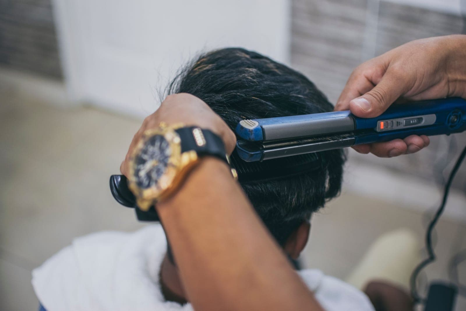 A flat iron pressing thick coarse hair